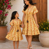 Mom & Daughter Yellow Ethnic Printed Matching Smocked Waist Flared Dress Set with Tassel Tie-Up Detail