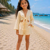 Girl’s Cream Solid Cotton Beach Wear Set with Bell Sleeve Tie-Up Top & Tassel Shorts