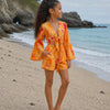 Girls Orange Abstract Printed Cotton Beach Wear Set with Bell Sleeve Tie-Up Top & Tassel Shorts