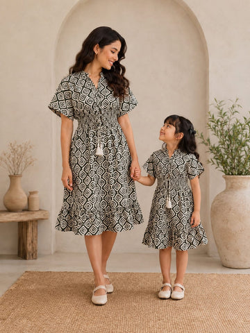 Mom & Daughter Monochrome Geometric Printed Matching Smocked Waist Flared Dress Set with Tassel Tie-Up Detail