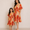Mom & Daughter Orange Tropical Leaf Printed Matching Smocked Waist Flared Dress Set with Tassel Tie-Up Detail